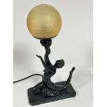 A reproduction Art Deco style lamp with seated dancer with arms upraised holding a golden craquelure