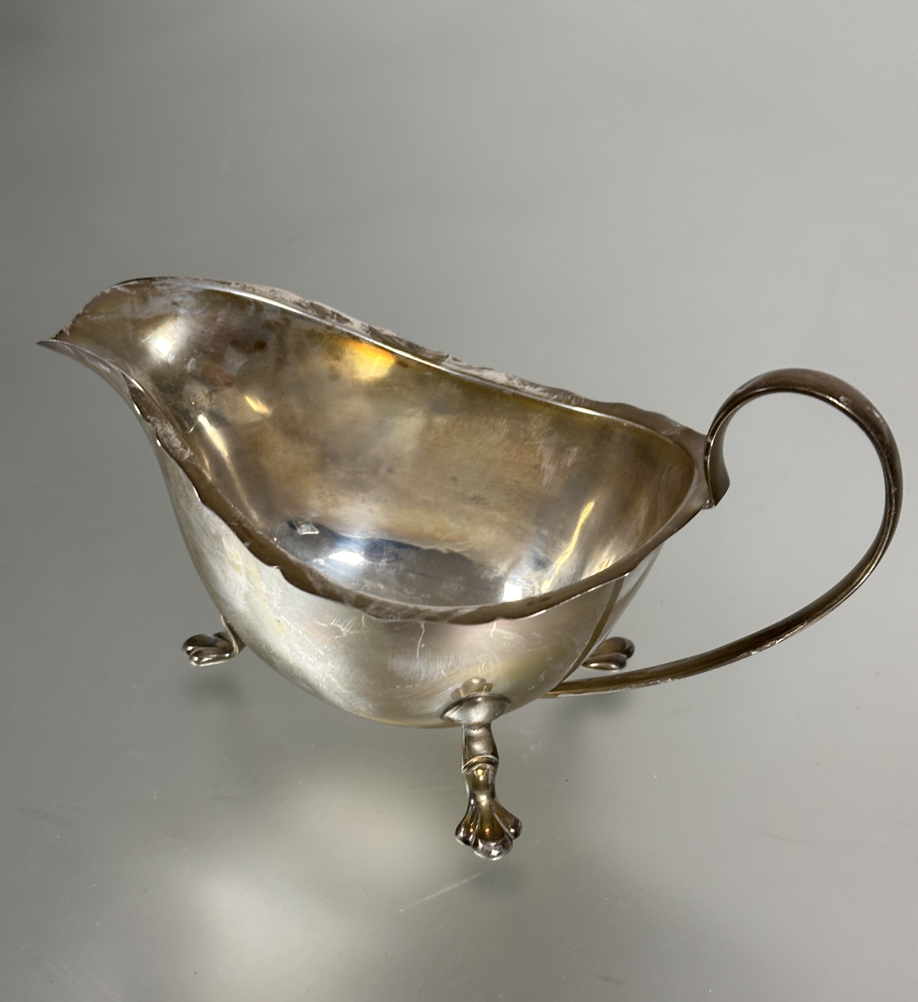 A Sheffield silver sauce boat with scalloped edge and C scroll handle raised on pad feet, (H x 8 - Image 2 of 2