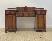 A late Georgian mahogany twin pedestal serving table, the arched ledge back above a bowed centre