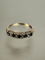 A 9ct gold five stone sapphire ring set four rows of two diamond points, P. 2.1g