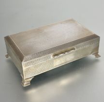 A Birmingham silver cigarette box, the rectangular box with all over engine turned decoration and