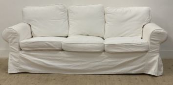 Ikea, a traditional three seat sofa, upholstered in loose white fitted cotton covers. H96cm, L216cm,
