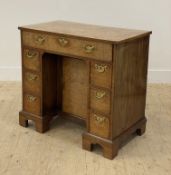 A George II style burr walnut knee hole desk, late 19th / early 20th century, the cross banded top