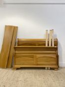 A light oak sleigh bed, with two panel head and foot boards. H110cm, W145cm.