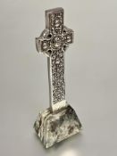 A Iona Scotland white metal Celtic cross with figure and mythical beast and serpent panel designs