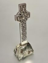 A Iona Scotland white metal Celtic cross with figure and mythical beast and serpent panel designs