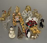 A collection of yellow and white metal enamel and paste set brooches including a snowman, teddy