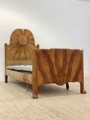 A Whytock and Reid figured oak single bed frame, early 20th century, the undulating headboard carved