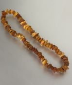 A dark honey and pale honey coloured natural nugget amber bead necklace, (L x 30cm) 77g