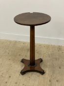 A mid 19th century mahogany pedestal table, the circular top a tapered octagonal column, raised on a