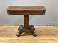 A William IV mahogany tea table, the fold over revolving top above a well figured frieze, the