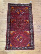 A hand knotted Turkish oushak rug, the red ground with geometric design and bordered 101cm x 190cm