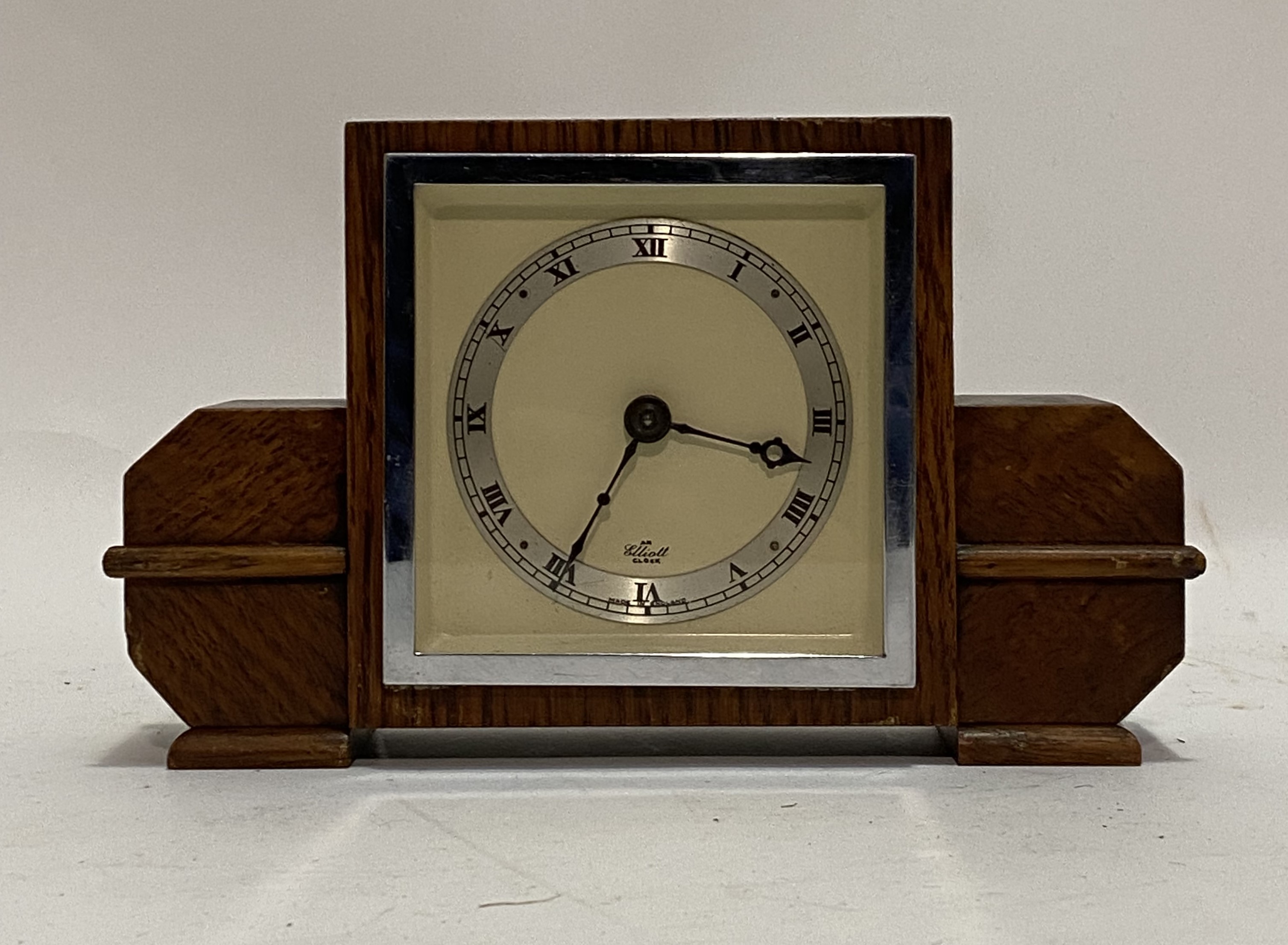 An Elliot Art Deco oak time piece mantel clock, early 20th century, the cream dial with silvered and