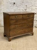 A George III mahogany chest, the top with moulded edge above two short and three long drawers,