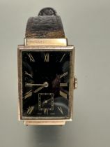 A gents 9ct gold cased 1930s Tank shaped wristwatch with black enamel dial and gilt roman numerals