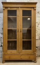 An glazed pine kitchen pantry cabinet, 20th century, with three shelves to interior, above a