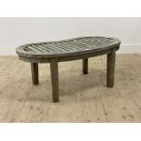 A silvered teak garden low table, the slatted top of kidney form on square section supports.