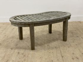 A silvered teak garden low table, the slatted top of kidney form on square section supports.