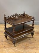 A mid 19th century rosewood whatnot, the top with floral fret cut three quarter gallery and urn