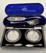 A pair of Birmingham silver butter dish pierced stands complete with crystal glass liners and silver