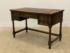 A Victorian oak knee hole desk of 18th century design, the top inset with leather writing surface
