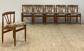 A set of six mid century teak dining chairs, the curved crest over wishbone splat and upholstered