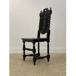 A 19th century Carolean style stained oak high back chair, with floral carved crest, splat and seat,