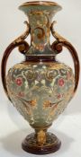 A German Majolica glazed twin handled vase by Wilhelm Schiller and Son decorated with raised