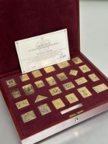 A Hallmark Replicas Empire Stamps Collection set of twenty five silver gilt stamps in original