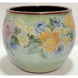 A large Chelsea Pottery jardiniere of squat form decorated with flowers in various colours, the