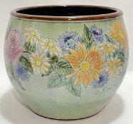 A large Chelsea Pottery jardiniere of squat form decorated with flowers in various colours, the