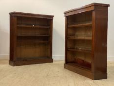 A pair of Victorian mahogany open bookcases, each fitted with three adjustable shelves, raised on