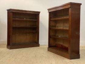 A pair of Victorian mahogany open bookcases, each fitted with three adjustable shelves, raised on