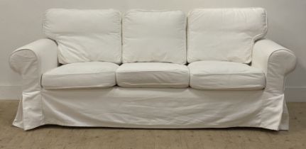 Ikea, a traditional three seat sofa, upholstered in loose white fitted cotton covers. H96cm, L216cm,