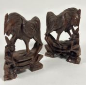 A pair of eastern carved wood cockerel figures with inset glass eyes, (H x 20 cm x W x 14 cm)