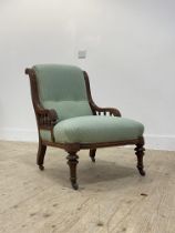 A Victorian walnut drawing room chair, with moulded show frame and elbow rests on a spindle gallery,