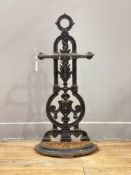 A Victorian cast iron stick stand, the back with floral and mask carved decoration above a drip tray