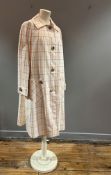 A 1970s Aquascutum lady's overcoat in cream with orange/yellow open line check (l.42" chest 40")