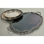 A Epns oval scalloped two handled drink tray, (L x 60 cm), an Epns circular engraved scalloped tray,