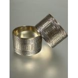 A pair of Sheffield silver engine turned napkin rings with engine turned decoration and initials RDF