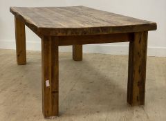 A large rustic farmhouse dining table, the plank top raised on square section supports. 214cm x
