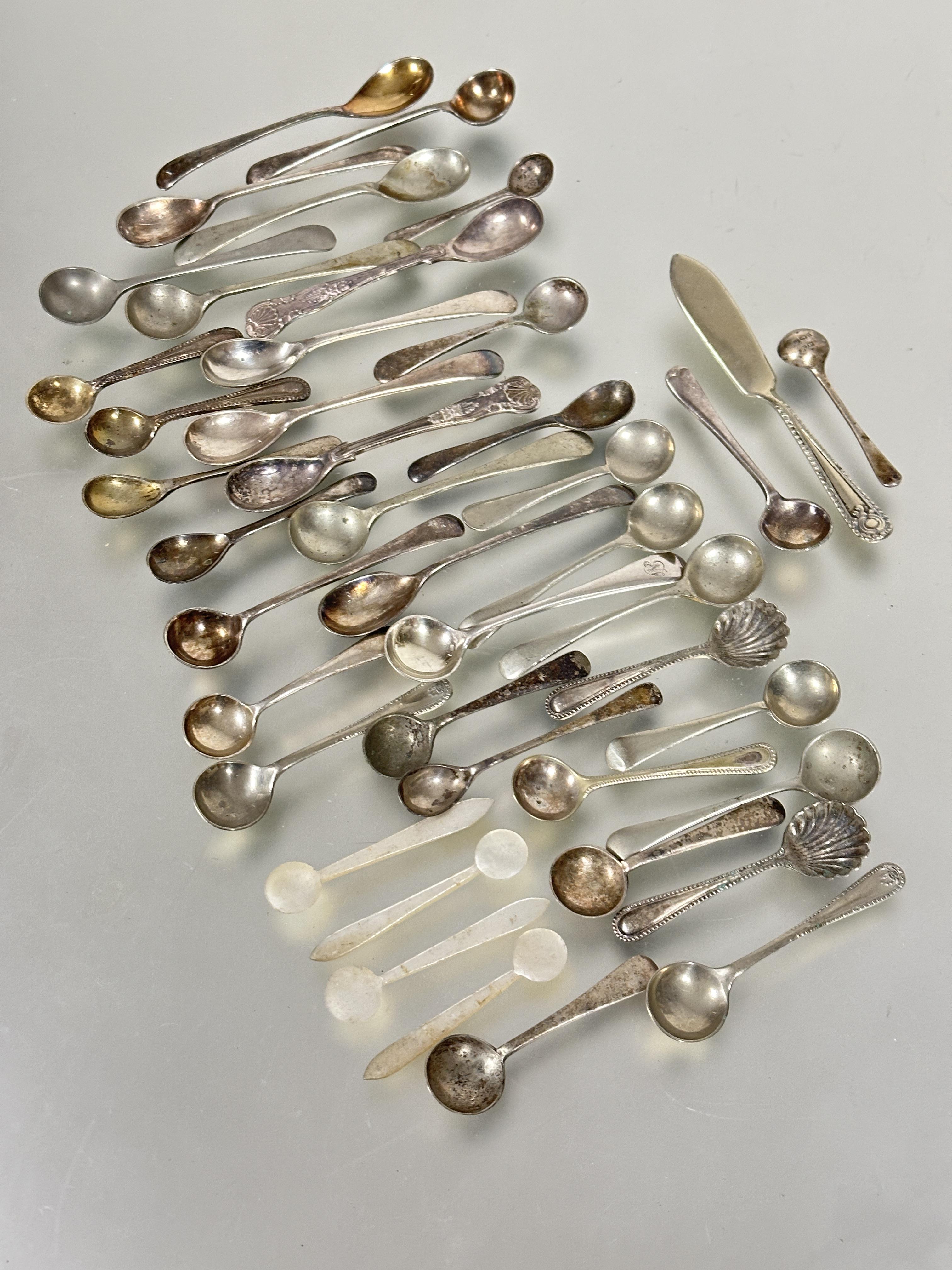 A group of five various silver mustard spoons, 20g, a set of four mother of pearl salt spoons,