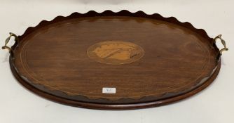 An Edwardian mahogany twin handled drinks tray, with scalloped gallery enclosing boxwood string