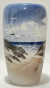 A Royal Copenhagen porcelain vase with coastal scene depicting gulls and waves on the shoreline (