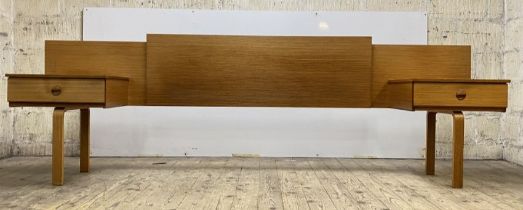 Schrieber, A mid century teak veneered headboard, the panelled back flanked by two integrated