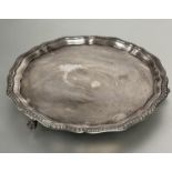 A Sheffield silver George III style drinks tray with scalloped gadroon border raised on claw and