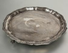 A Sheffield silver George III style drinks tray with scalloped gadroon border raised on claw and