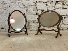 An early 20th century Georgian style inlaid mahogany vanity mirror, the oval plate swivelling