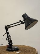 An Anglepoise type lamp with conical shade and circular base, finished in black.