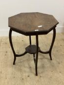 A late Victorian oak centre table, with an octagonal top raised on shaped supports united by an
